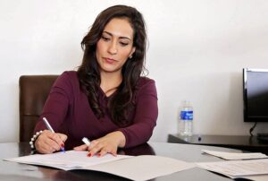 woman filling out paper