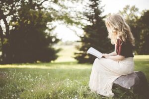 woman reading a book in the park