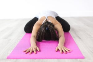 woman doing extended child's pose (a yoga move)